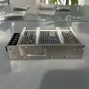 Omron S8FS-C10024J — bottom face showing the vertical terminal block with the AC input side (L / N / PE) and the 24 VDC output side (+V / -V)