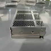 Omron S8FS-C10024J DIN-rail mounted in a small control cabinet with a CP1L PLC, terminal blocks, and cable ducts