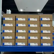 Omron S8FS-G05024CD — labeled cartons stacked on warehouse shelving