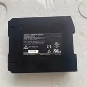 Omron S8VK-C06024 power supply - front face showing the slim 32 mm wide housing, the V.ADJ output-voltage trimmer, the green DC ON LED, and the finger-safe input and output screw-terminal covers.