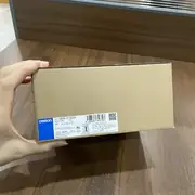 Omron S8VK-G12024 120 W DIN-rail power supply — installed on a 35 mm DIN rail in a control cabinet next to an S8VK-G06024 (60 W) and an S8VK-G24024 (240 W), all powering the same 24 VDC bus system with parallel-balance LEDs visible