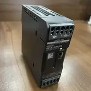 Omron S8VK-S06024 power supply - side view showing the 35 mm DIN-rail mounting clip and the coated metal housing for harsh environments