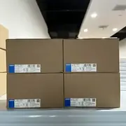 Omron S8VK-S48024 — four sealed cartons stacked with model labels facing forward