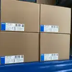 Omron S8VK-T24024 — four labeled cartons stacked on warehouse shelving