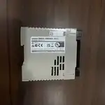 Omron S8VS-06024A 60 W switch-mode PSU — side view showing the 35 mm DIN-rail mounting clip and the slim 40 × 95 × 108 mm form factor with finger-safe screw terminals