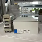 Omron S8VS-12024 switching power supply — close-up of the screw-terminal output block showing the V+ / V− / FG terminal markings and the output voltage adjustment potentiometer