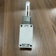 Omron WLCA12-2N-N two-circuit limit switch — top view of the head showing the head direction lock bolt (M4) and the four-position mounting direction indicator (vertical up, vertical down, horizontal left, horizontal right)