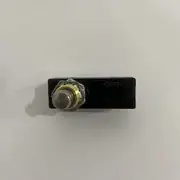 Omron Z-15GQ-B basic switch — installed through a panel cutout in a control cabinet door, with the plunger protruding through the panel and the three screw terminals wired to a door-interlock signal returning to a safety controller