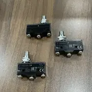 Omron Z-15GQ55-B basic switch — side view of the snap-action mechanism showing the SPDT terminal block with the NO / COM / NC screw posts and the contact-gap data plate