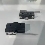 Omron Z-15GW4-B — front view of the black thermoset resin body showing the four M3.5 screw terminals on the rear, the hinge lever actuator on the front, and the Z marking on the body