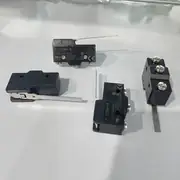 Omron Z-15GW4-B mounted on a conveyor guard frame with the hinge lever aligned to a passing cam, dropping out a relay when the guard swings shut